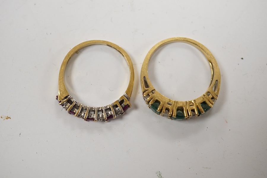 A modern 18ct gold, ruby and diamond set half hoop ring, size M and a yellow metal emerald and diamond set half hoop ring, size L/M, gross weight 6 grams. Condition - poor to fair